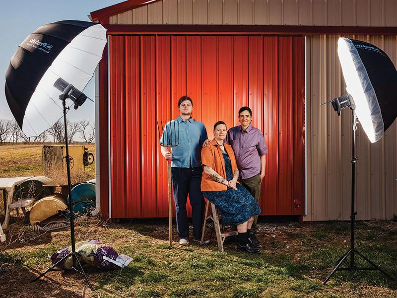 Midwest queer family poses before television lights. 